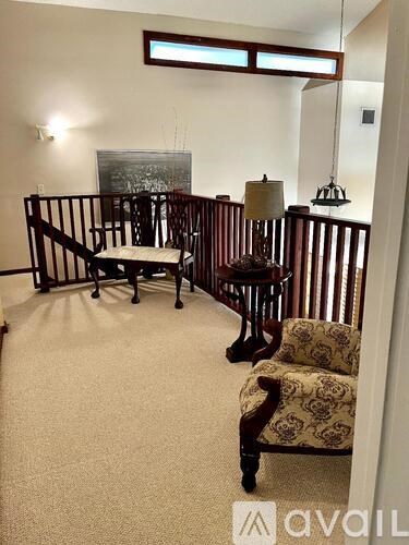 A kitchen with a marble countertop and white cabinets.