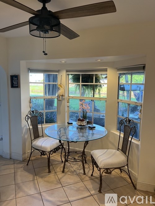 A dining room with a table and chairs.