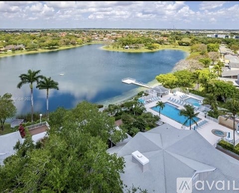 A boat is sitting on the grass by the water.
