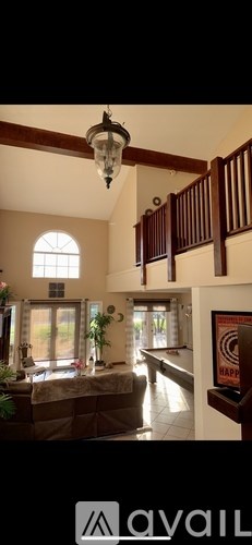 A living room with a couch and a window.