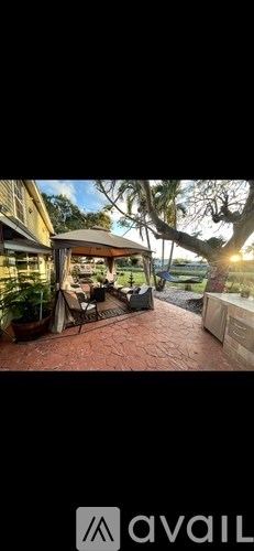 A patio area with a table and chairs under a canopy.