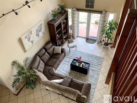 A living room with a couch, chair, and coffee table.