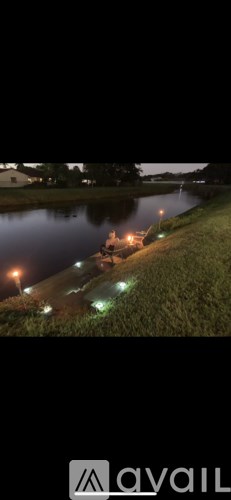 A body of water with lights reflecting on the surface.