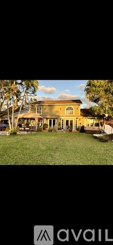 A large, two-story house with a spacious front yard.