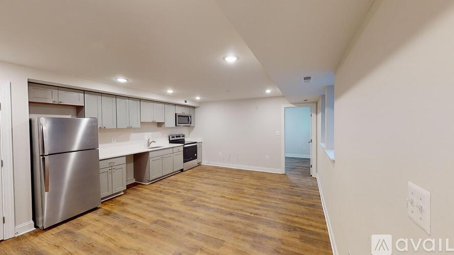 A kitchen with a refrigerator, microwave, and oven.