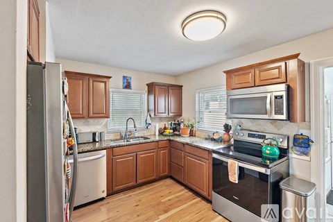 A kitchen with wooden cabinets and stainless steel appliances.