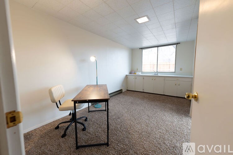 A room with a desk and a chair.