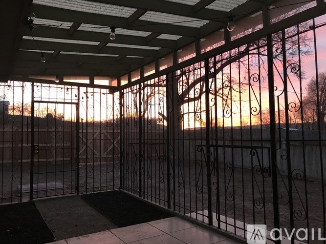 A sunset view through a wrought iron gate.