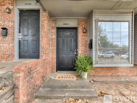 The front door of a house with a sign that says "Welcome".