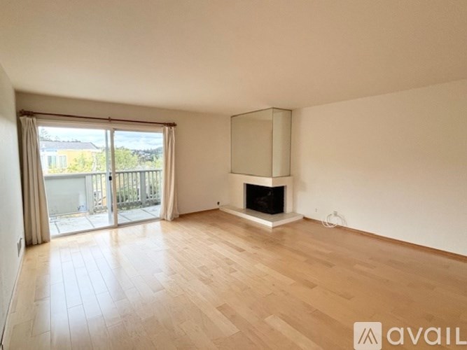A spacious room with a fireplace and sliding glass doors.
