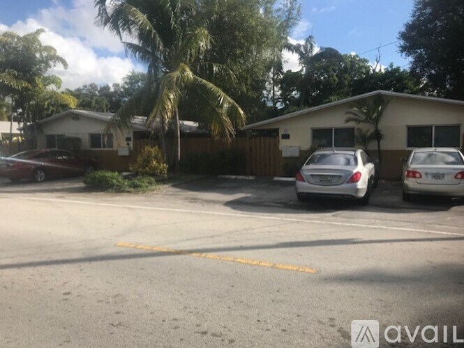 A car is parked in a yellow line on the street.