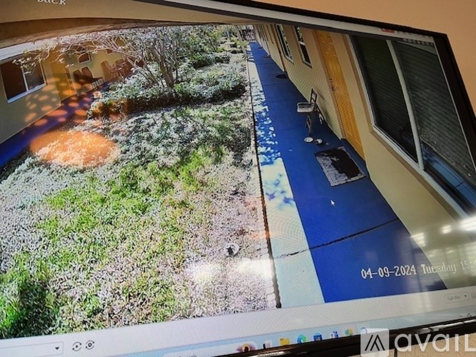 A security camera displays a view of a residential area.
