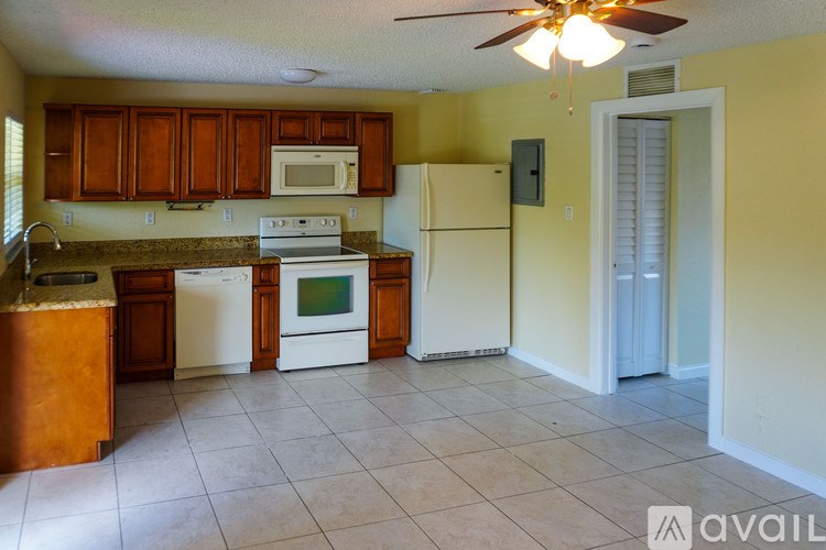 A kitchen with a white refrigerator and a white oven.