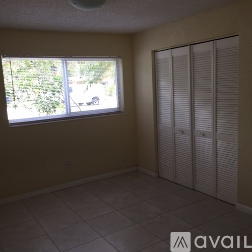 A room with a window and a sliding door.