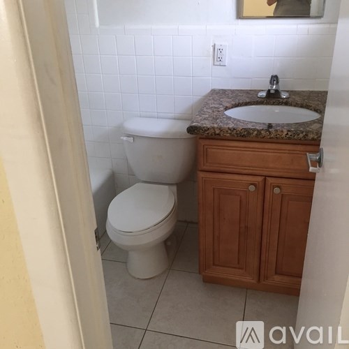 A white toilet sits next to a sink in a bathroom.