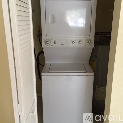 A white dishwasher is in a small kitchen.