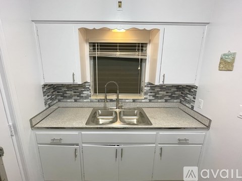 A kitchen with a sink and cabinets.