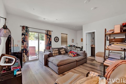 A living room with a couch, a chair, and a table.