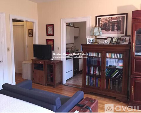 A living room with a blue sofa and a television.