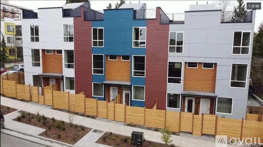 A row of modern townhouses with different colored exteriors.