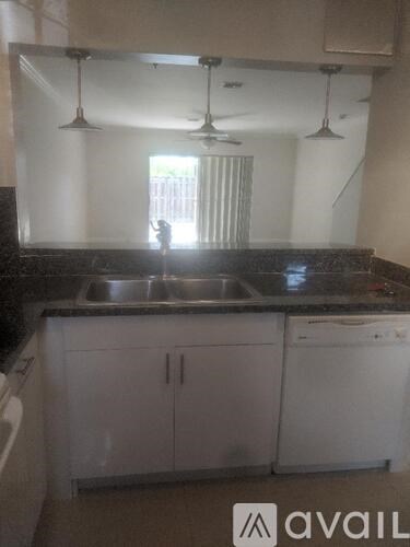 A kitchen with a sink and a window.