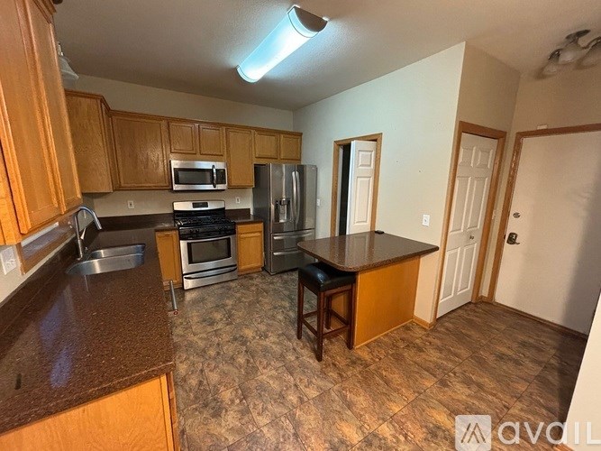 A kitchen with wooden cabinets and a brown countertop.