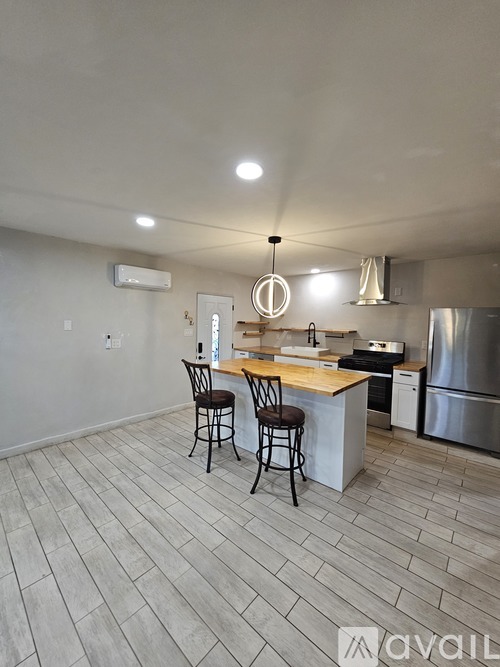 A kitchen with a bar stool and a counter.