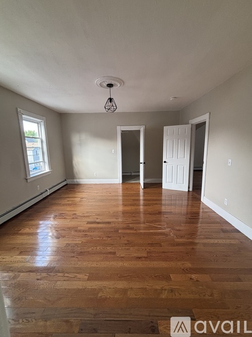 A room with wooden floors and white walls.