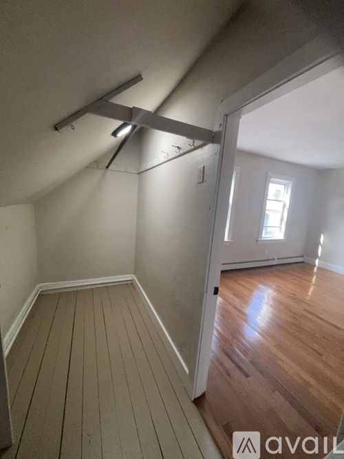 A room with wooden floors and a window.