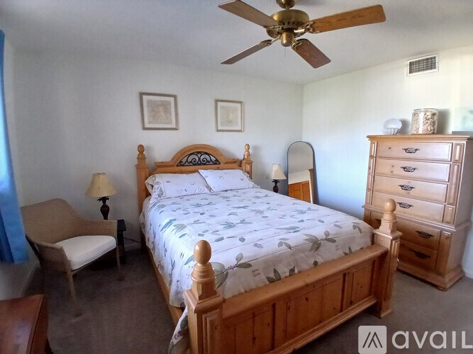 A bedroom with a bed, dresser, and mirror.