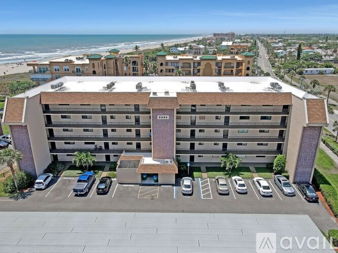 A large building with a parking lot in front of it.