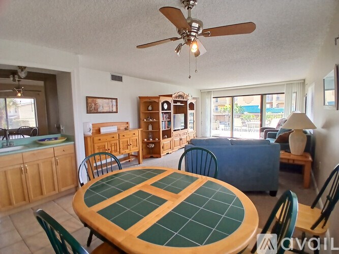 A dining room with a table and chairs.