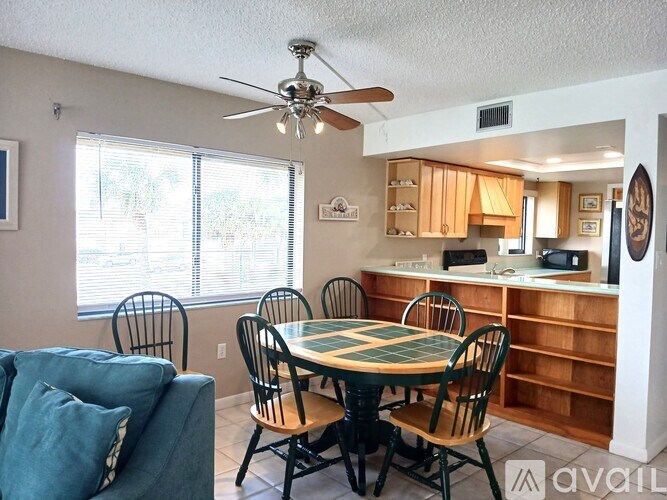 A dining room with a table set for four.