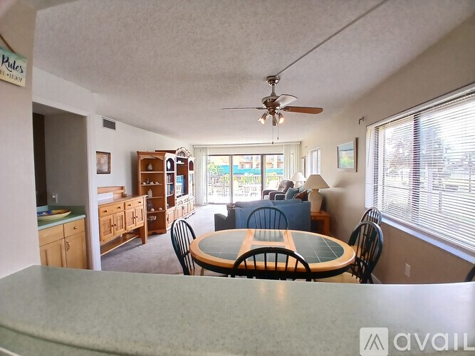 A living room with a dining table and chairs.