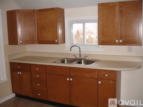 A kitchen with wooden cabinets and a sink.