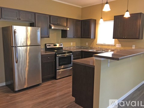 A kitchen with a stainless steel refrigerator and oven.