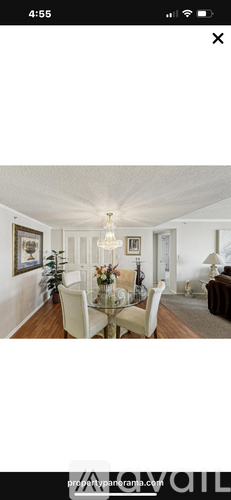 A dining room with a glass table and chairs.