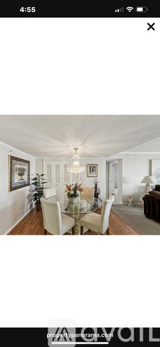 A dining room with a glass table and chairs.