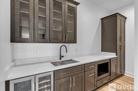 A kitchen with brown cabinets and white countertops.