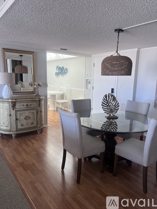 A dining room with a glass table and chairs.