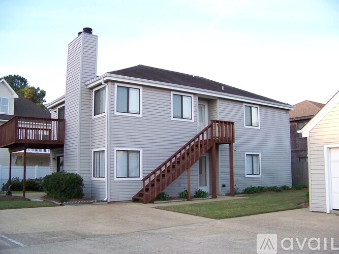 A two-story house with a garage and a balcony.