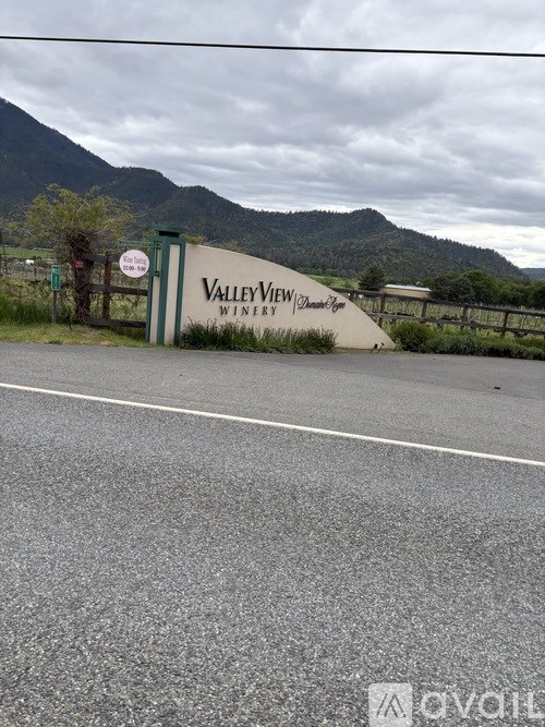 A sign for Valleyview Winery is in front of a mountain.