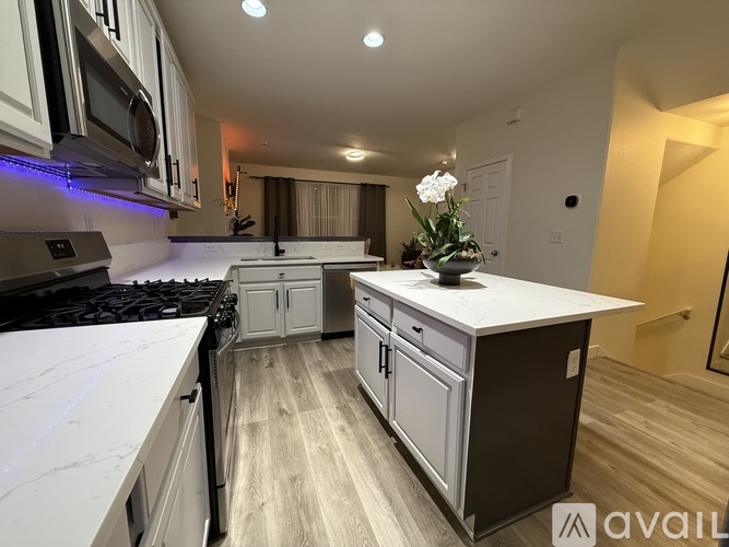 A kitchen with a white countertop and a stove top oven.