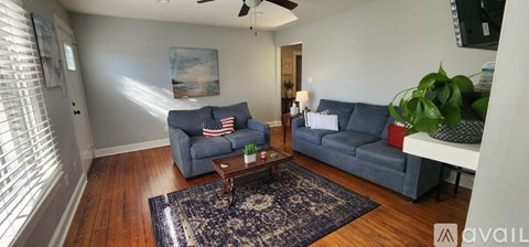 A living room with a grey couch and a coffee table.