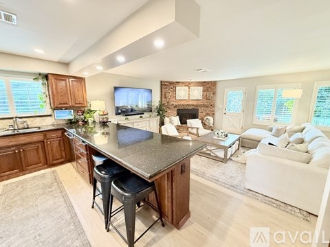 A kitchen with a bar stool and a countertop.