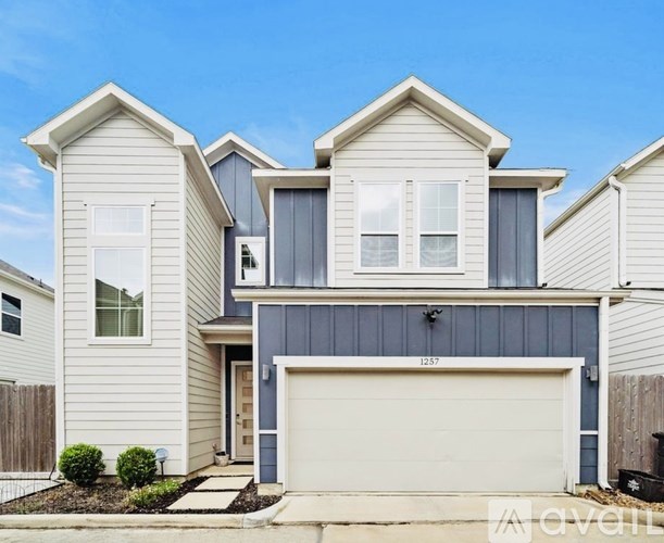 A modern two-story house with a garage.