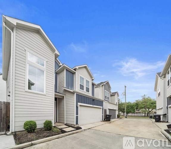 A row of houses with a clear blue sky above them.