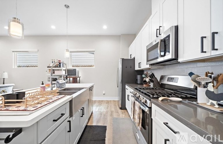 A modern kitchen with a large island and stainless steel appliances.
