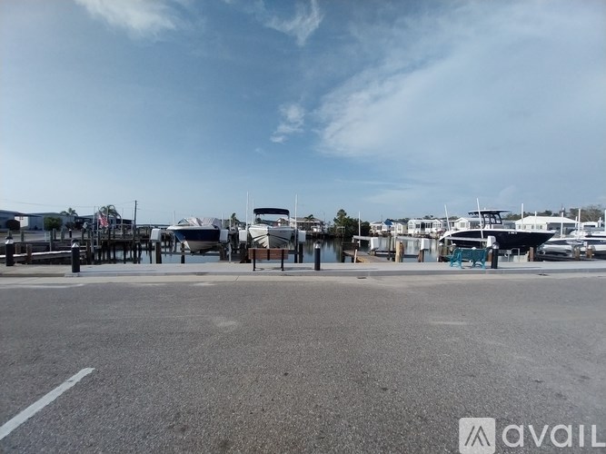 A parking lot with a clear sky and some buildings in the background.