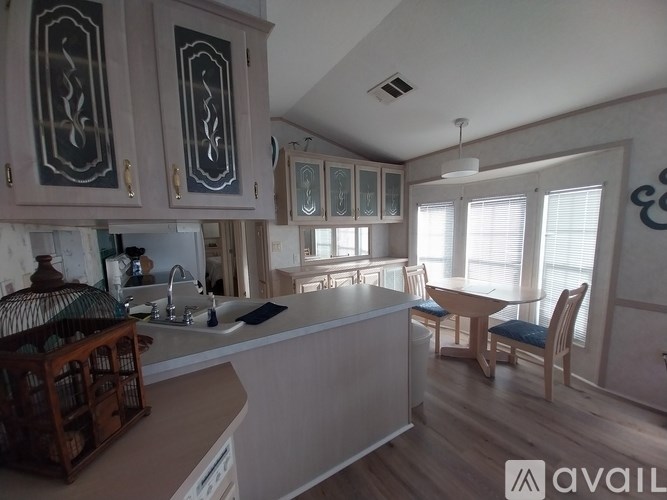 A kitchen with a table and chairs in the living room.